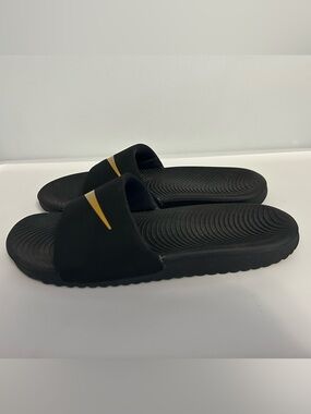 Nike Black Slides with Gold Swoosh Accent